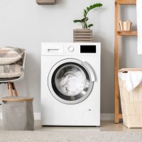 Interior of home laundry room with modern washing machine